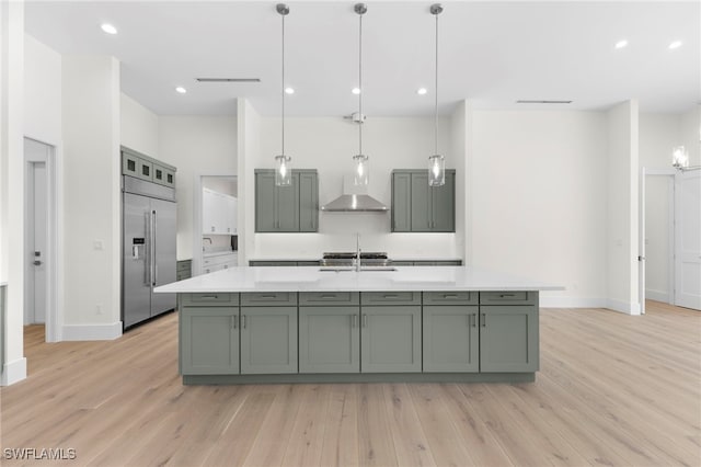 3509 5th Ave SW, Naples, FL 34117 - kitchen featuring stainless steel built in refrigerator, wall chimney exhaust hood, light countertops, baseboards, and recessed lighting