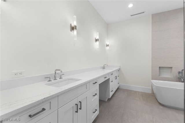 bathroom with a washtub and vanity