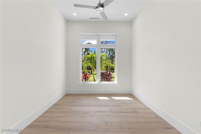 empty room with light hardwood / wood-style floors and ceiling fan