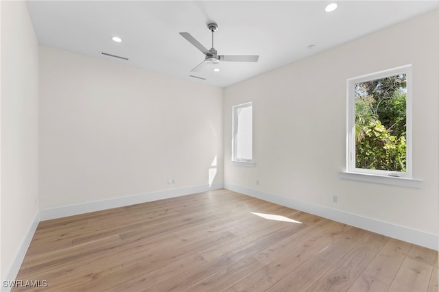 spare room featuring ceiling fan and light hardwood / wood-style flooring