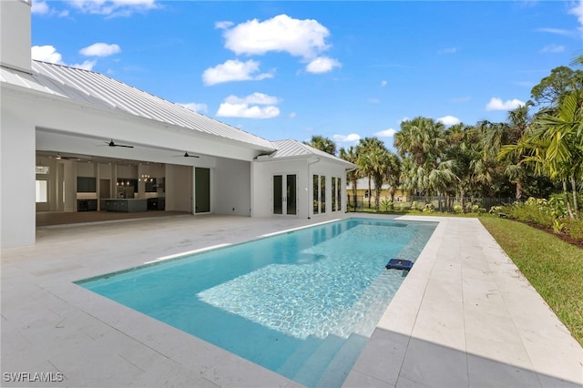 view of pool with a patio area and ceiling fan