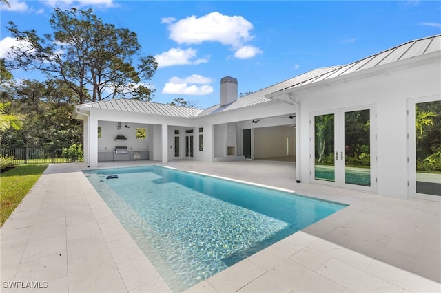 view of pool with french doors, a grill, and a patio area