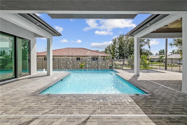 view of swimming pool featuring pool water feature and a patio