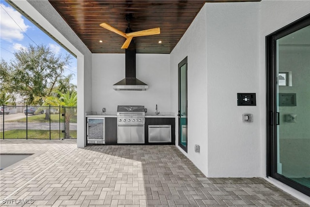 view of patio / terrace featuring sink, an outdoor kitchen, ceiling fan, and a grill