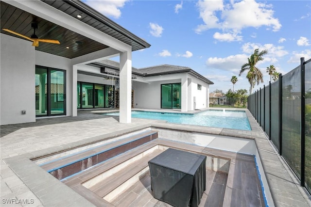 view of pool with ceiling fan, pool water feature, and a patio