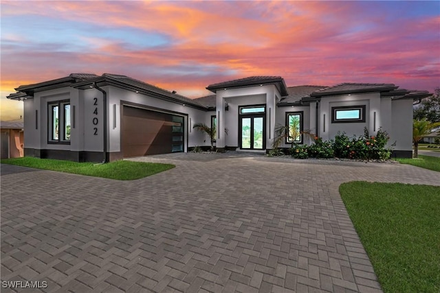 prairie-style house with a garage and french doors