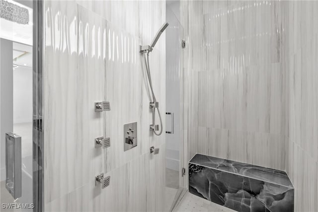 bathroom with a shower with door