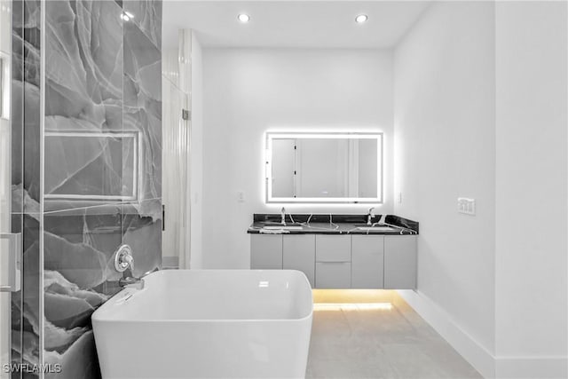 bathroom with vanity and a tub to relax in