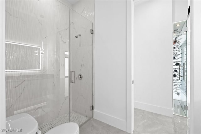 bathroom with a shower with door and toilet