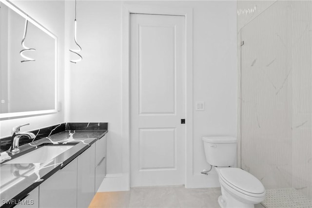 bathroom featuring toilet, vanity, tile patterned floors, and walk in shower