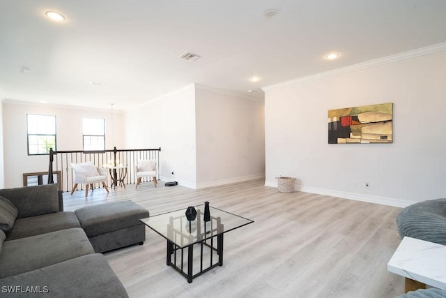 living room with light wood-type flooring and crown molding