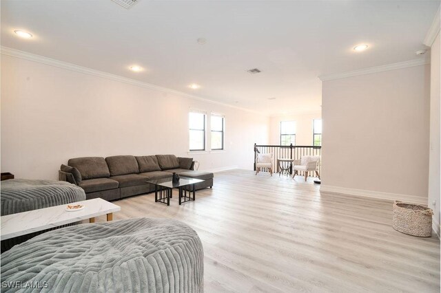 living room featuring light wood-type flooring and crown molding