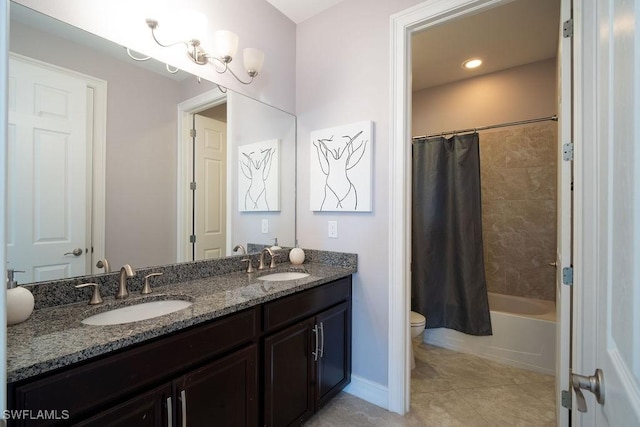 full bathroom with tile patterned floors, shower / bath combo with shower curtain, vanity, and toilet