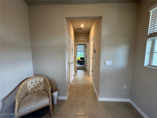 corridor featuring light tile patterned flooring