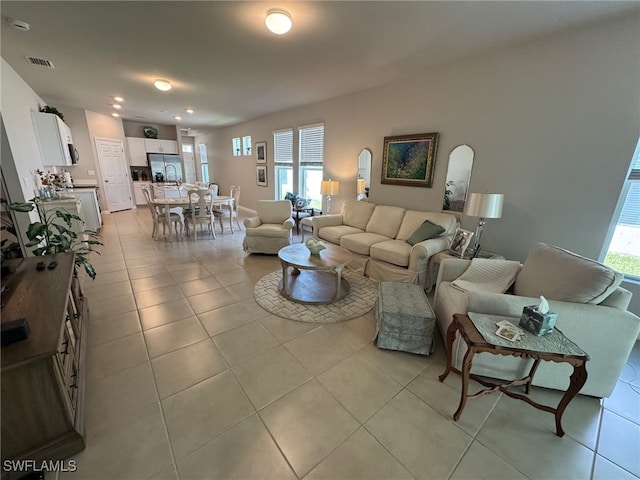 living room with a healthy amount of sunlight and light tile patterned floors