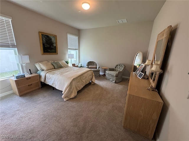 carpeted bedroom featuring multiple windows