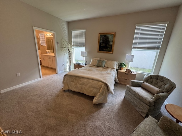 carpeted bedroom featuring ensuite bath