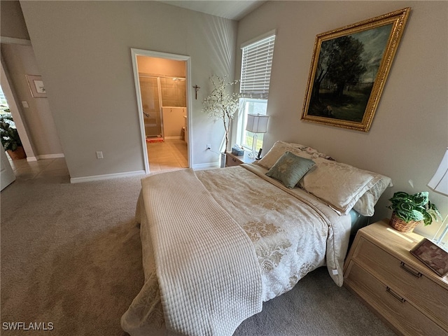 carpeted bedroom with ensuite bath and multiple windows