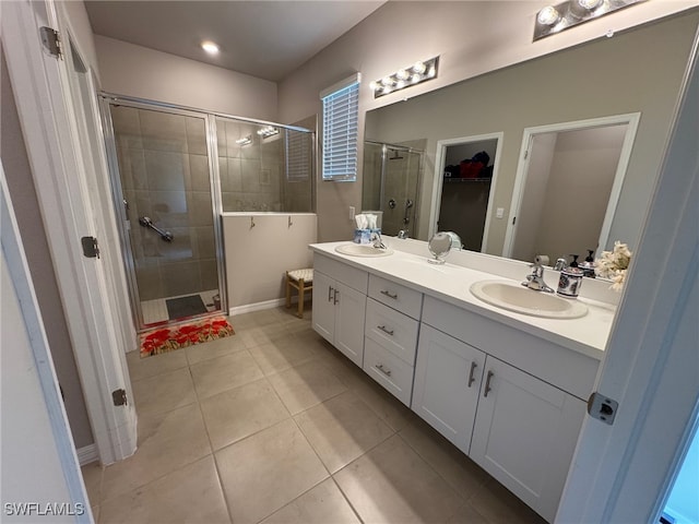 bathroom featuring vanity, tile patterned floors, and a shower with shower door