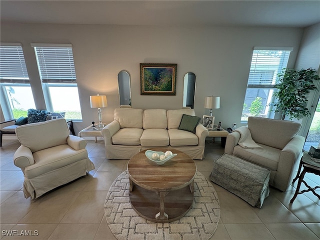 living room featuring light tile patterned flooring and a healthy amount of sunlight