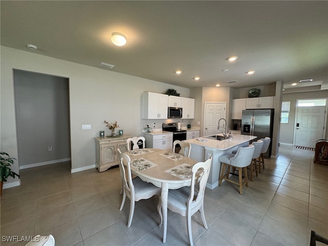 tiled dining area featuring sink