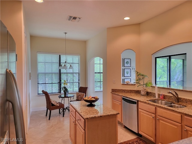 kitchen featuring a notable chandelier, sink, stainless steel dishwasher, light stone countertops, and light brown cabinets