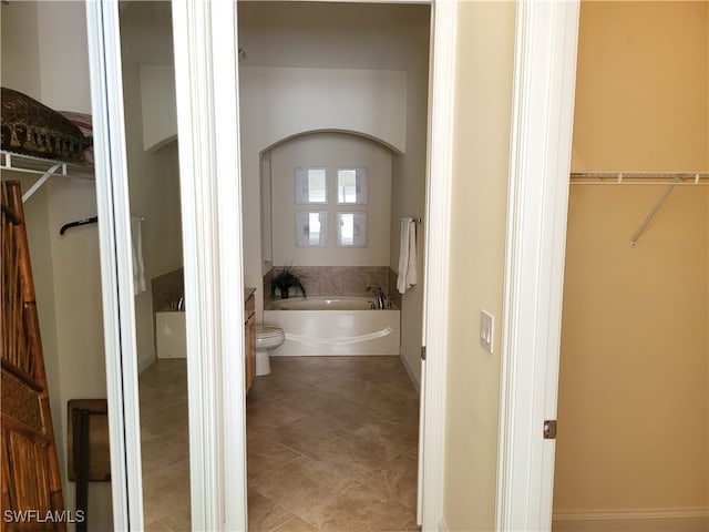 bathroom with a bathtub and tile patterned floors