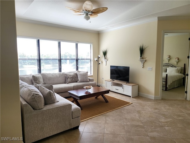 tiled living room with ceiling fan and crown molding