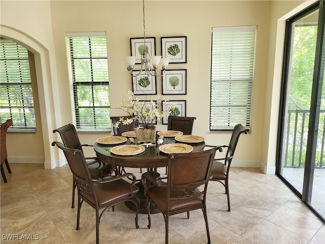 dining area with plenty of natural light and a chandelier