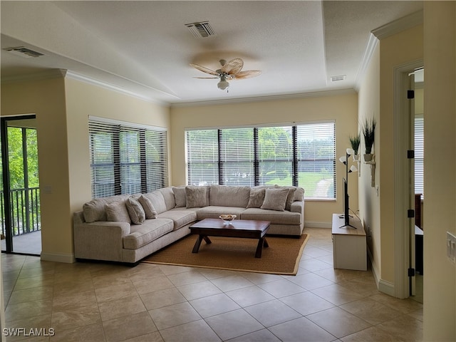 tiled living room with a wealth of natural light, ceiling fan, and ornamental molding