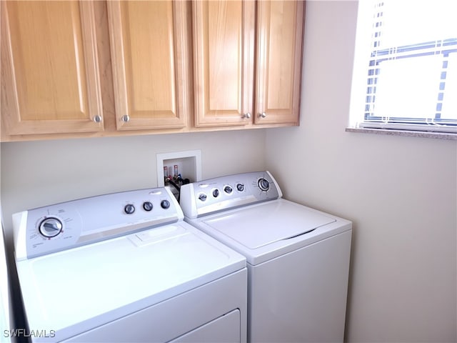 laundry room with cabinets and separate washer and dryer