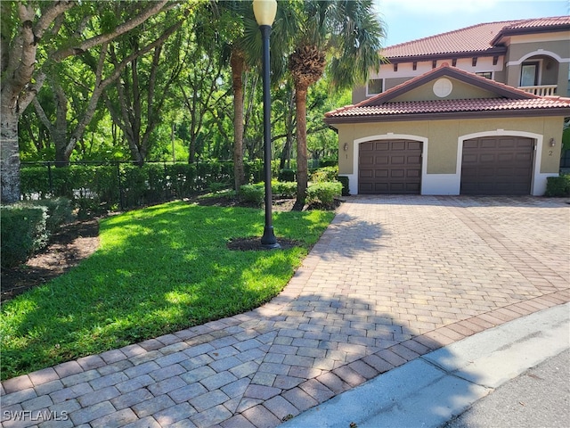 view of front facade featuring a front yard and a garage