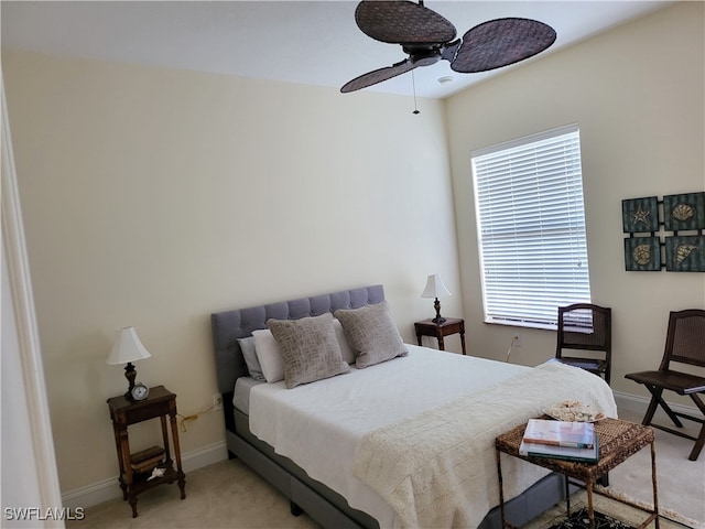 bedroom featuring light colored carpet and ceiling fan