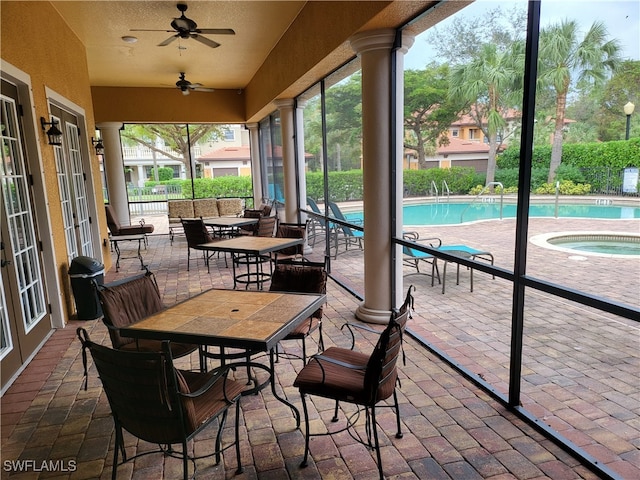 view of patio / terrace featuring ceiling fan and a swimming pool with hot tub