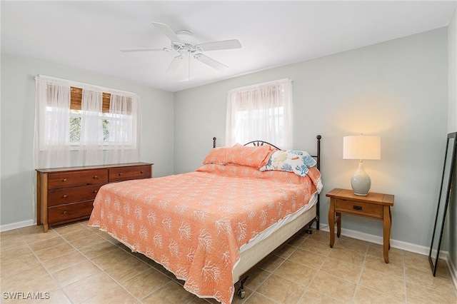 bedroom featuring multiple windows, ceiling fan, and light tile patterned flooring