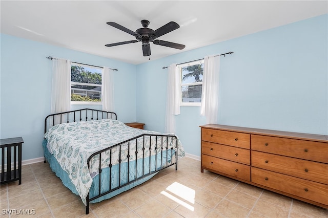 bedroom with ceiling fan and light tile patterned floors