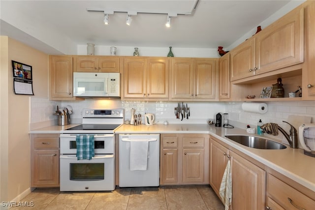 kitchen featuring decorative backsplash, light brown cabinetry, white appliances, and sink