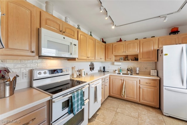 kitchen with sink, light tile patterned floors, backsplash, light brown cabinetry, and white appliances