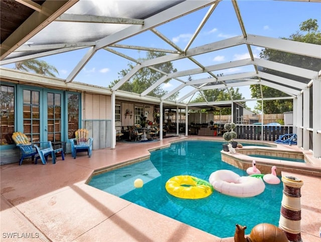 view of swimming pool featuring a lanai, a patio, and an in ground hot tub