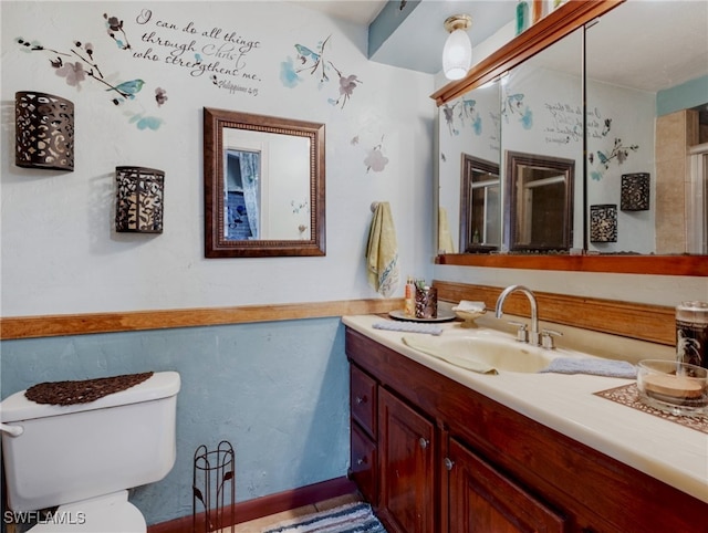 bathroom featuring toilet and vanity