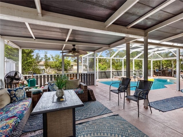 view of patio with a lanai, ceiling fan, a fenced in pool, and outdoor lounge area