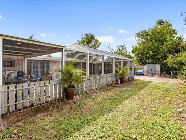 view of yard featuring glass enclosure and a shed