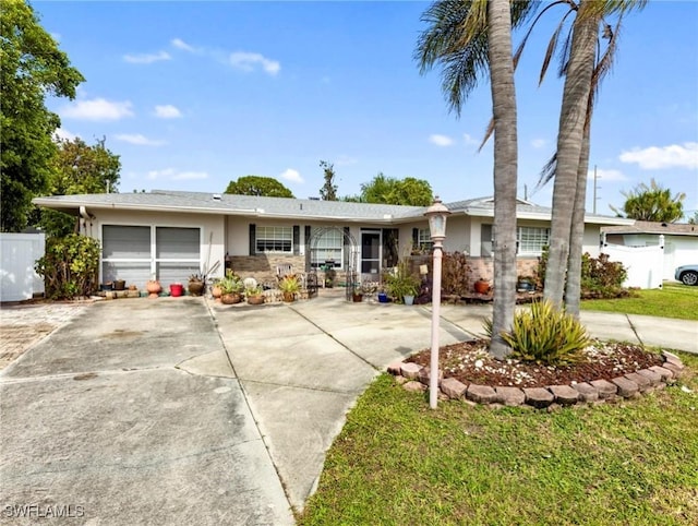 ranch-style home with a front yard and a garage