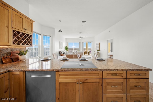 kitchen with light stone counters, kitchen peninsula, black electric cooktop, and ceiling fan