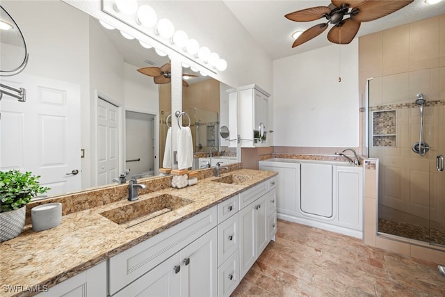 bathroom with a shower with door, ceiling fan, and vanity