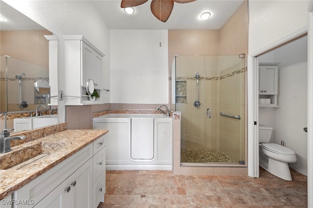 full bathroom featuring independent shower and bath, toilet, ceiling fan, and vanity