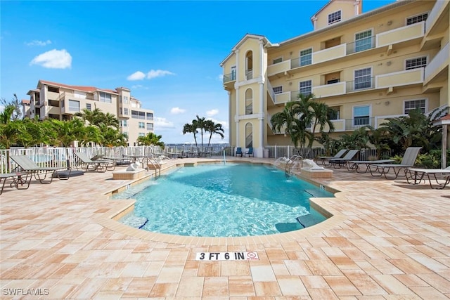 view of pool featuring pool water feature and a patio