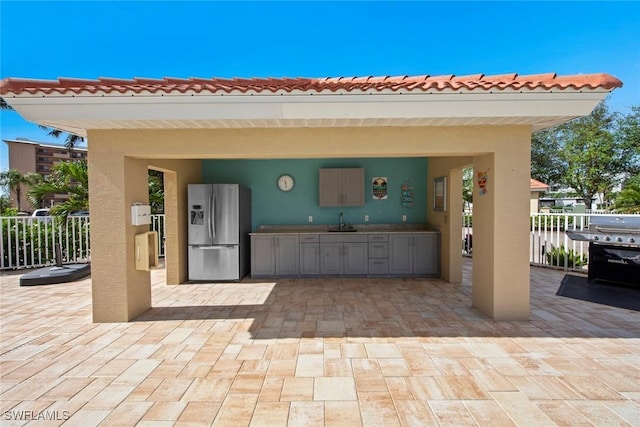 view of patio / terrace featuring sink and a water view