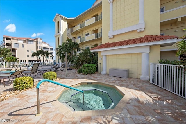 view of pool with a patio area and a hot tub