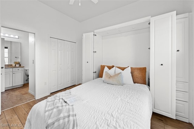 bedroom with ceiling fan, light hardwood / wood-style flooring, and ensuite bath